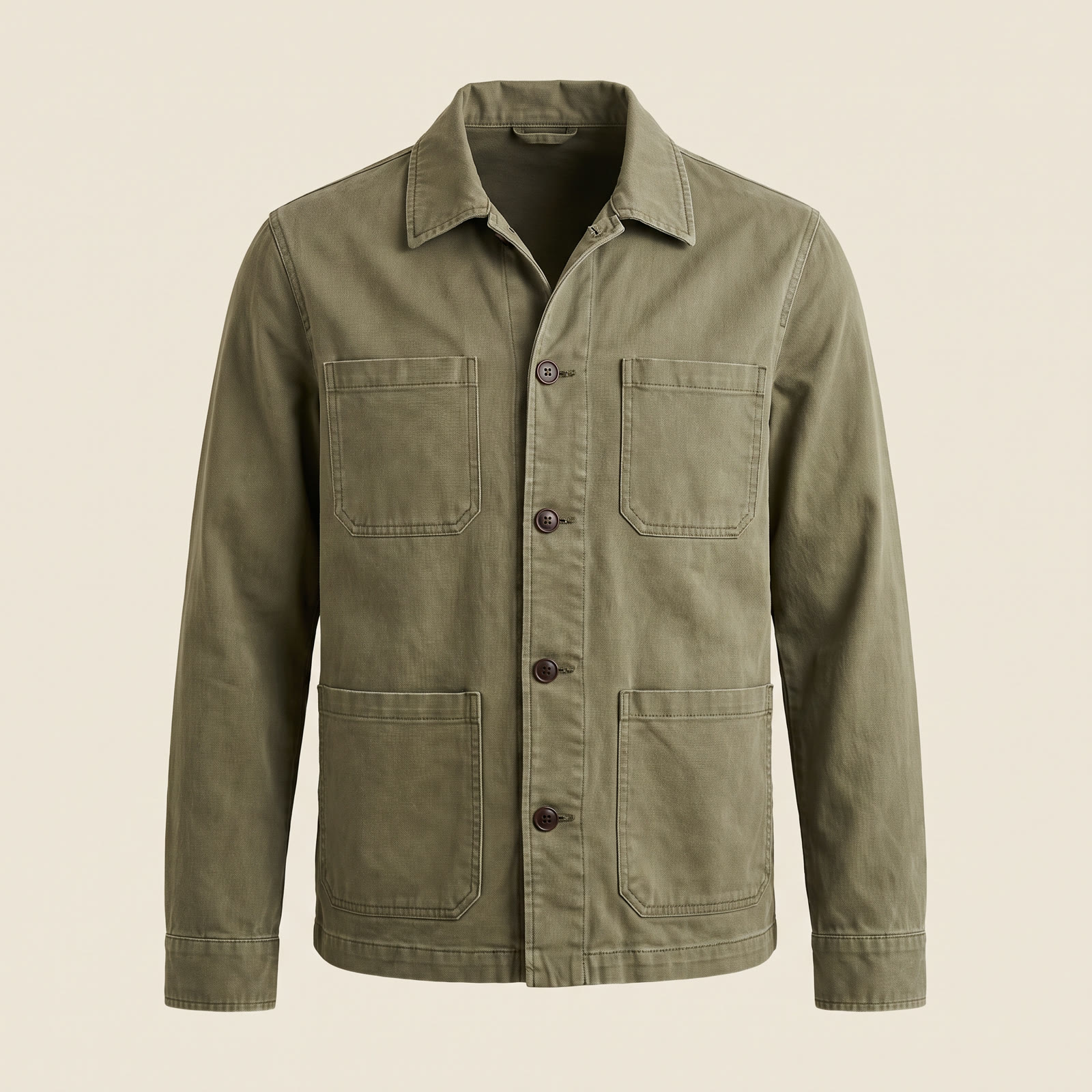 An olive-green cotton chore jacket with four patch pockets and dark buttons on an invisible mannequin