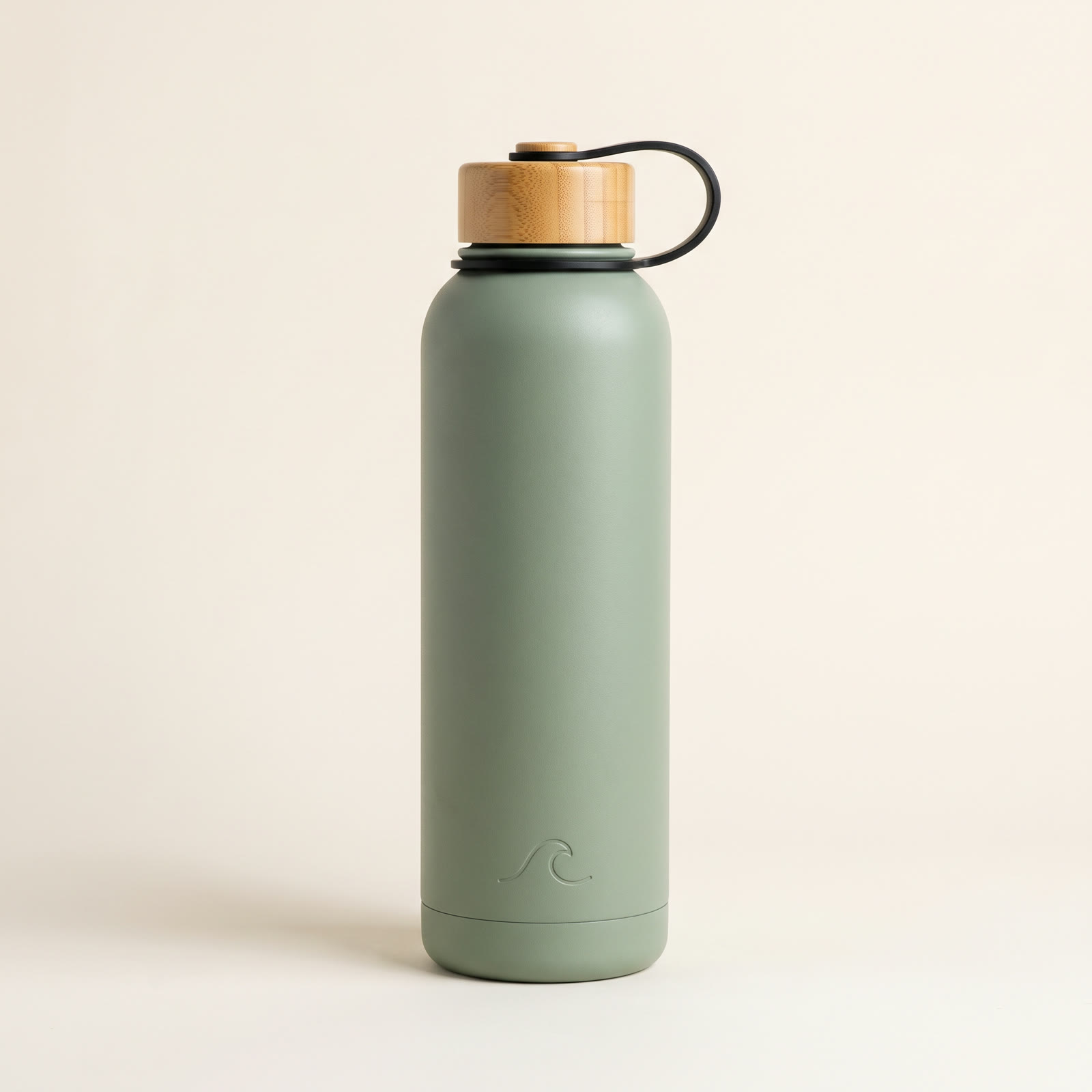 A matte sage-green insulated water bottle with a bamboo cap and a black carry loop on a plain warm-white background