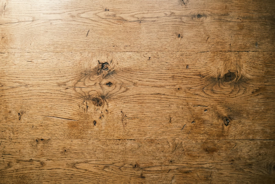 An empty weathered oak table top in morning light
