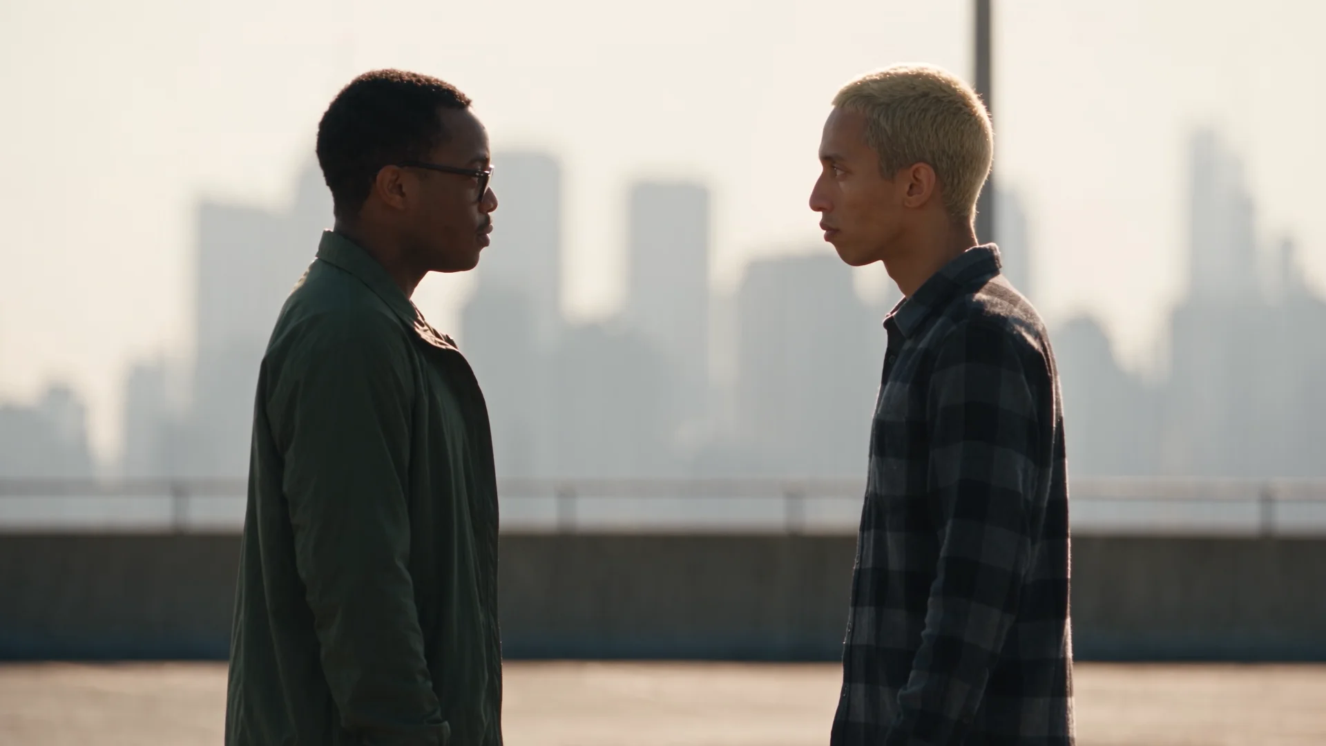 Profile two-shot of the two men facing each other against the skyline