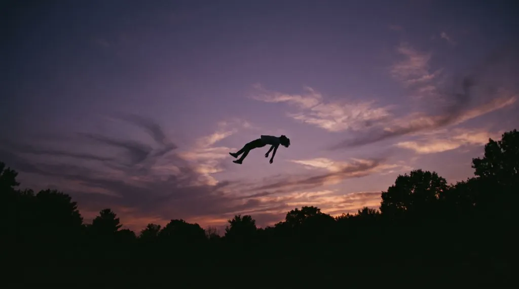 Reference still of a person silhouetted mid-air against a dusk sky